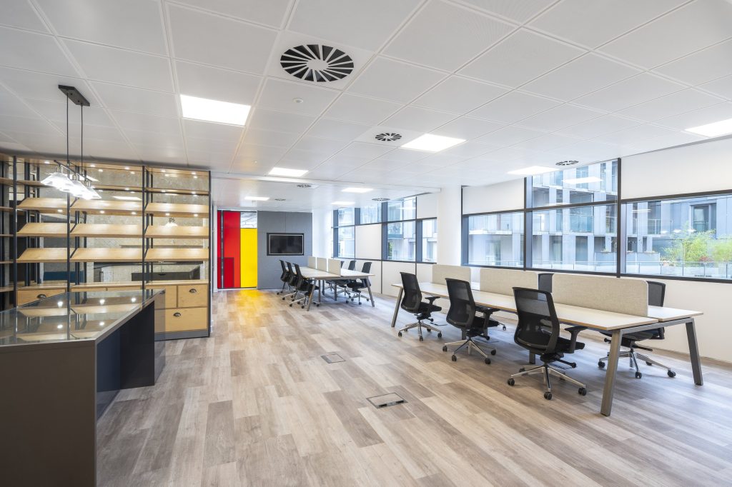 Newly refurbished office space in The Poppy Building, located in Brewhouse Yard, London's Tech Hub, featuring floor-to-ceiling windows and a communal roof terrace.
